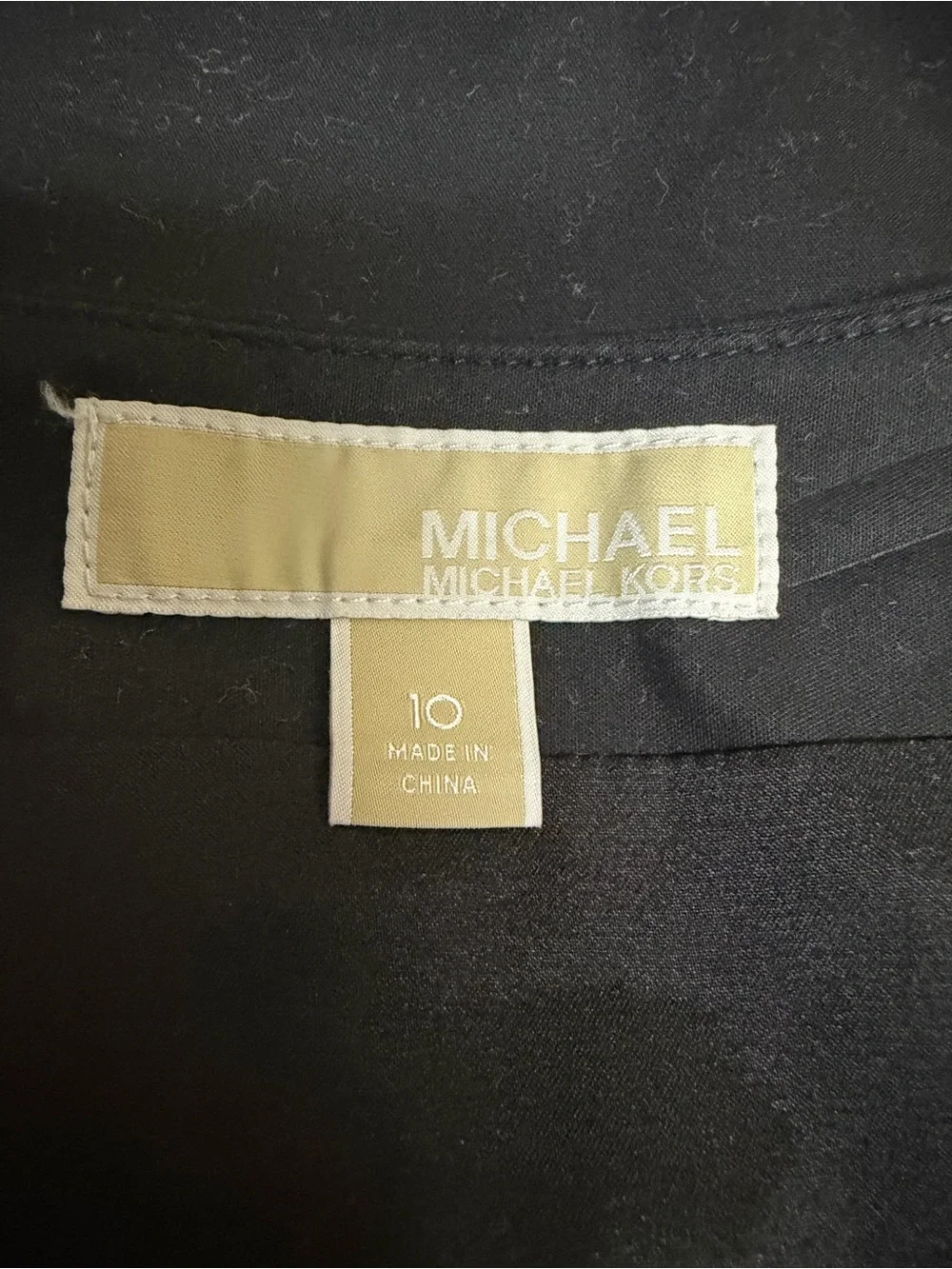 Michael Kors black lined mini skirt with double row silver buttons
